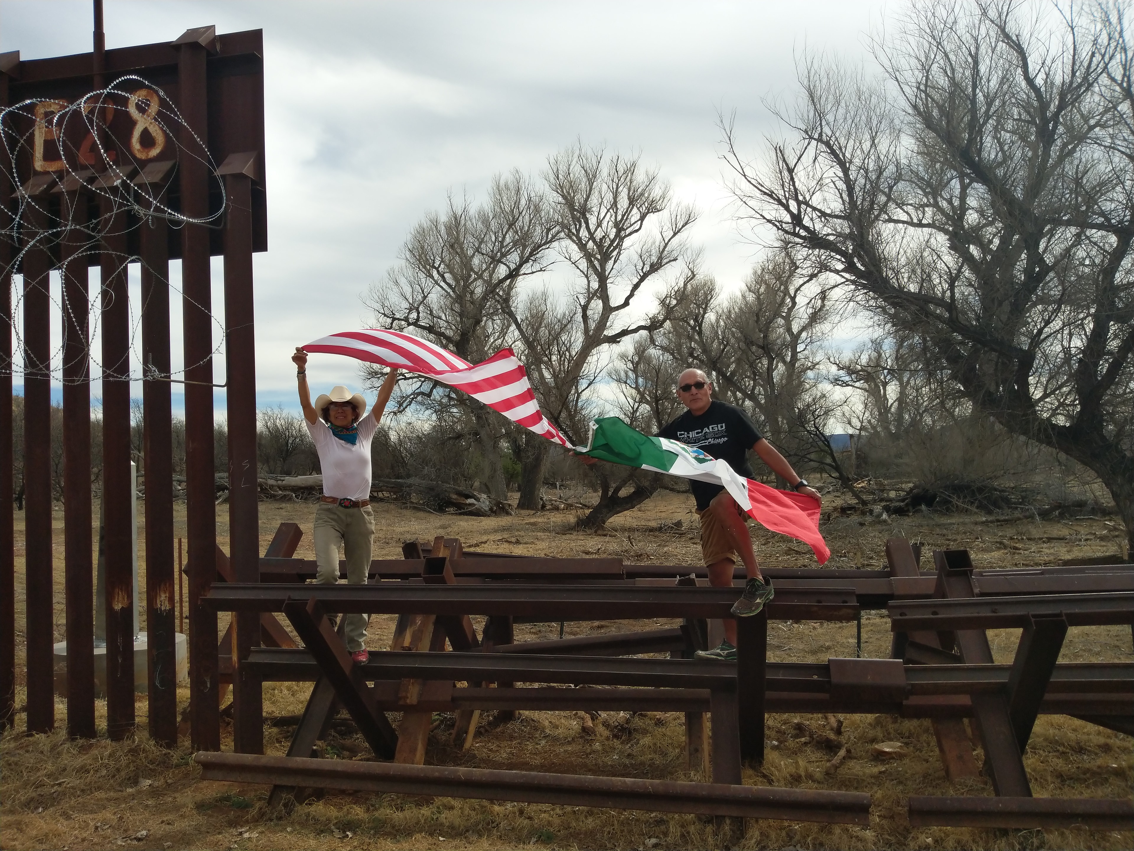 Raechel Running and Ricardo at the barrier wall on the Santa Cruz River, where the Santa Cruz reenters Arizona after venturing through Sonora, Mexico. The Santa Cruz is the only river in North America that meanders northward — nature knows no boundaries. Photograph by Raechel Running, well-known photographer and activist. by Ricardo Santos Hernández